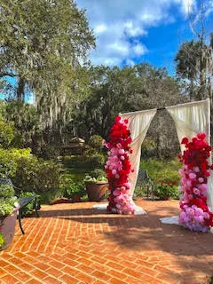 A draping installation with florals and soft pink balloons.